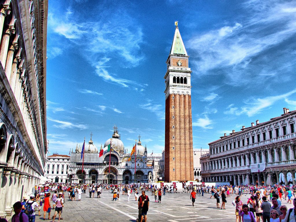 image of san marco square with view of the clock tower and the venice basilica